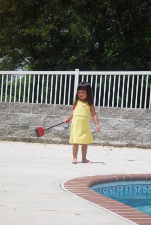 Kasen cleaning up by the pool